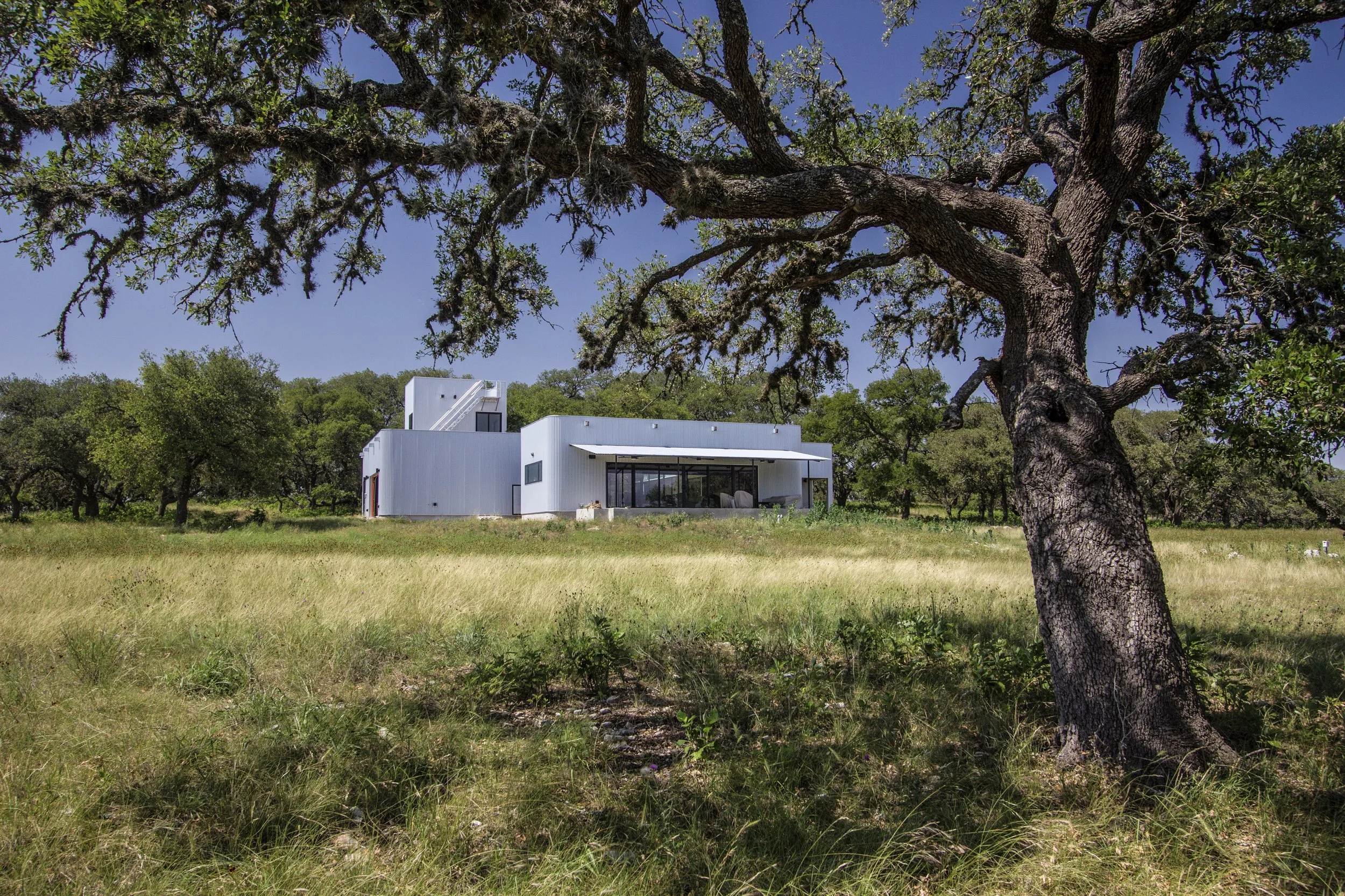 The Outpost exterior with live oak canopy