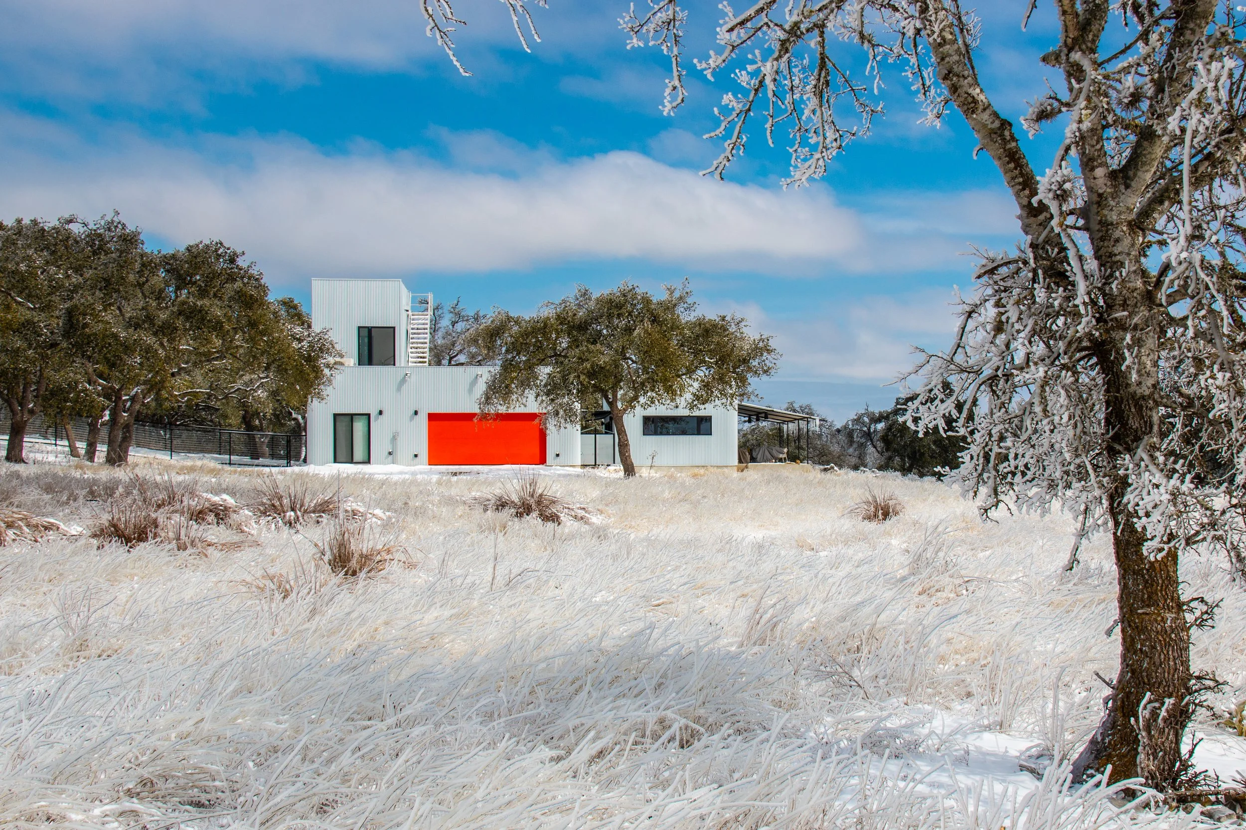 The Outpost exterior beneath live oak trees