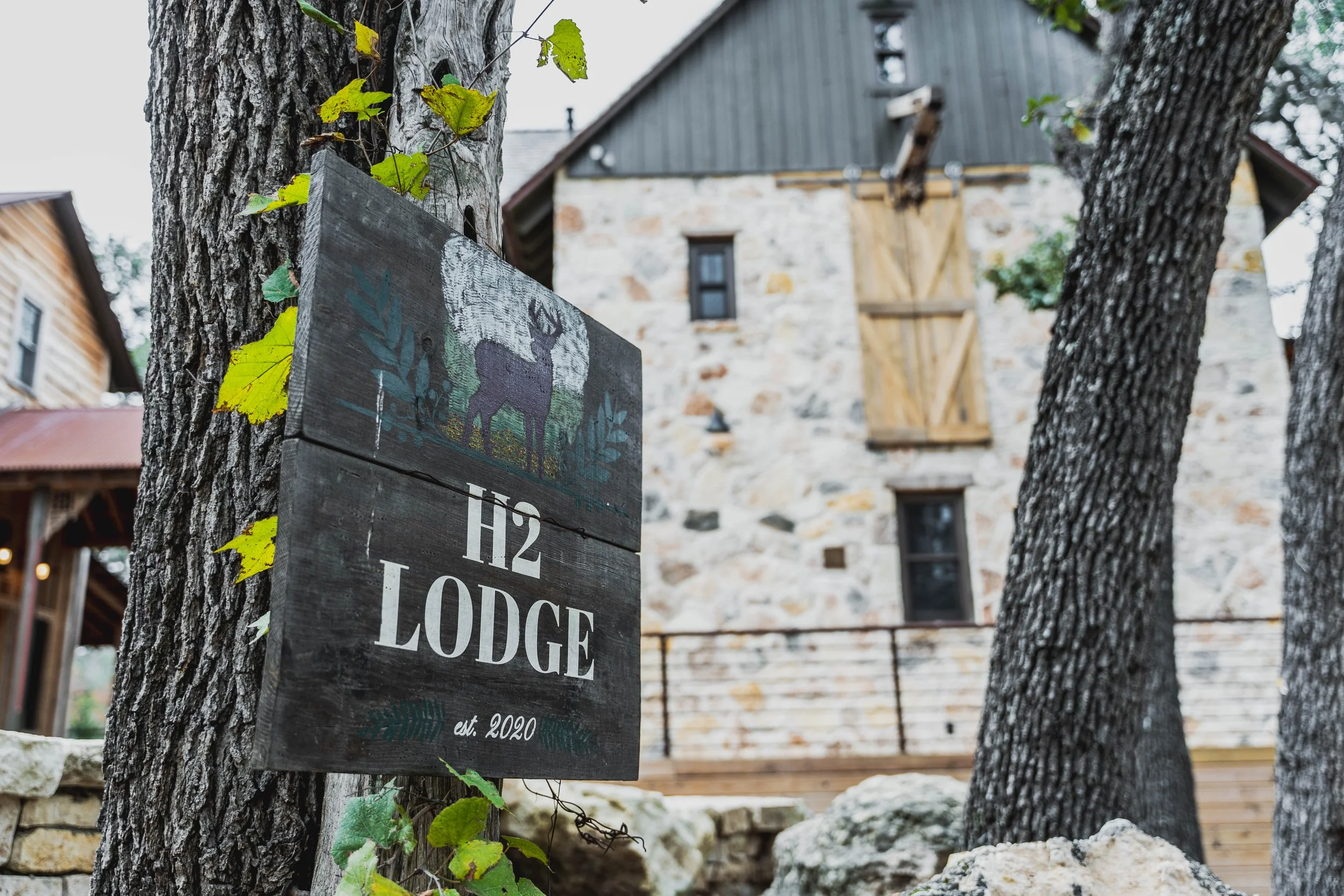 H2 Lodge great room with stone fireplace