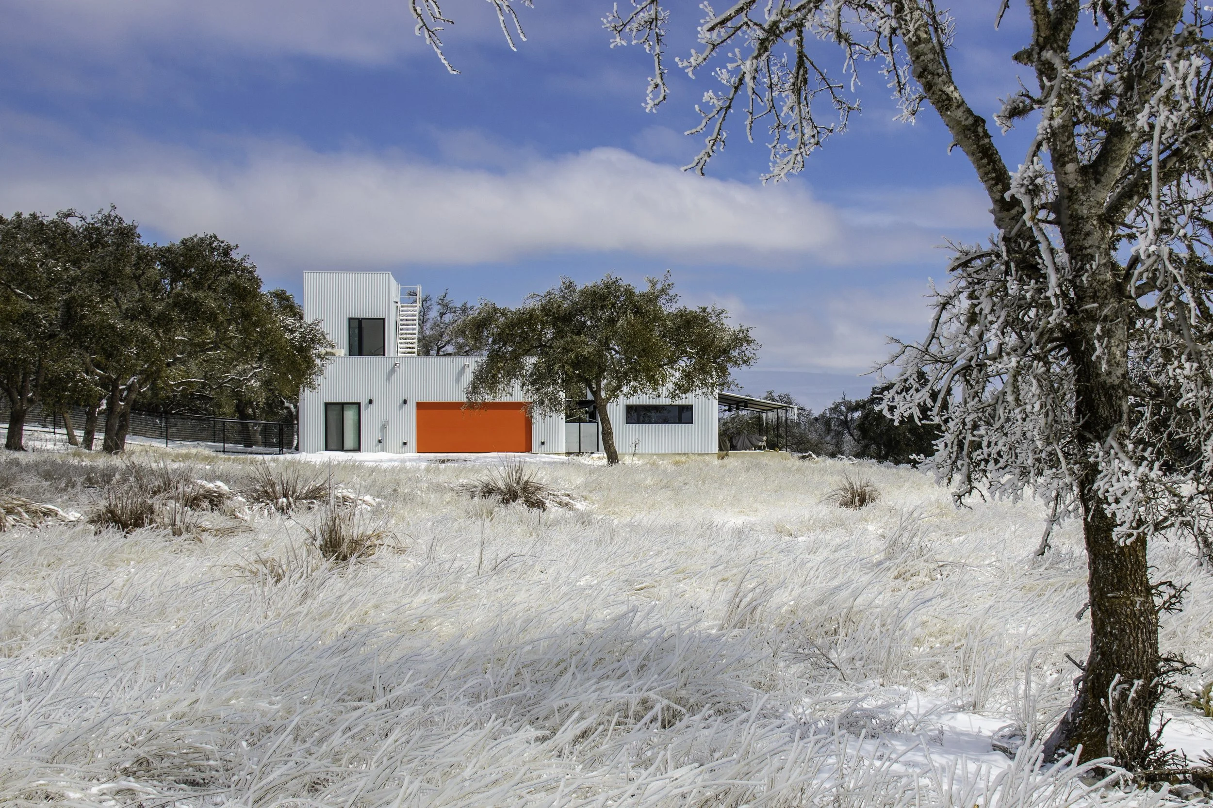 The Outpost exterior beneath live oak trees