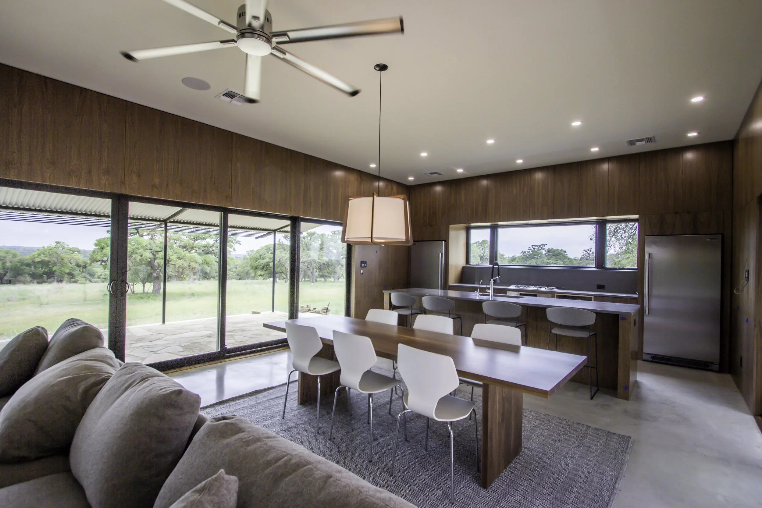 The Outpost modern exterior framed by live oaks