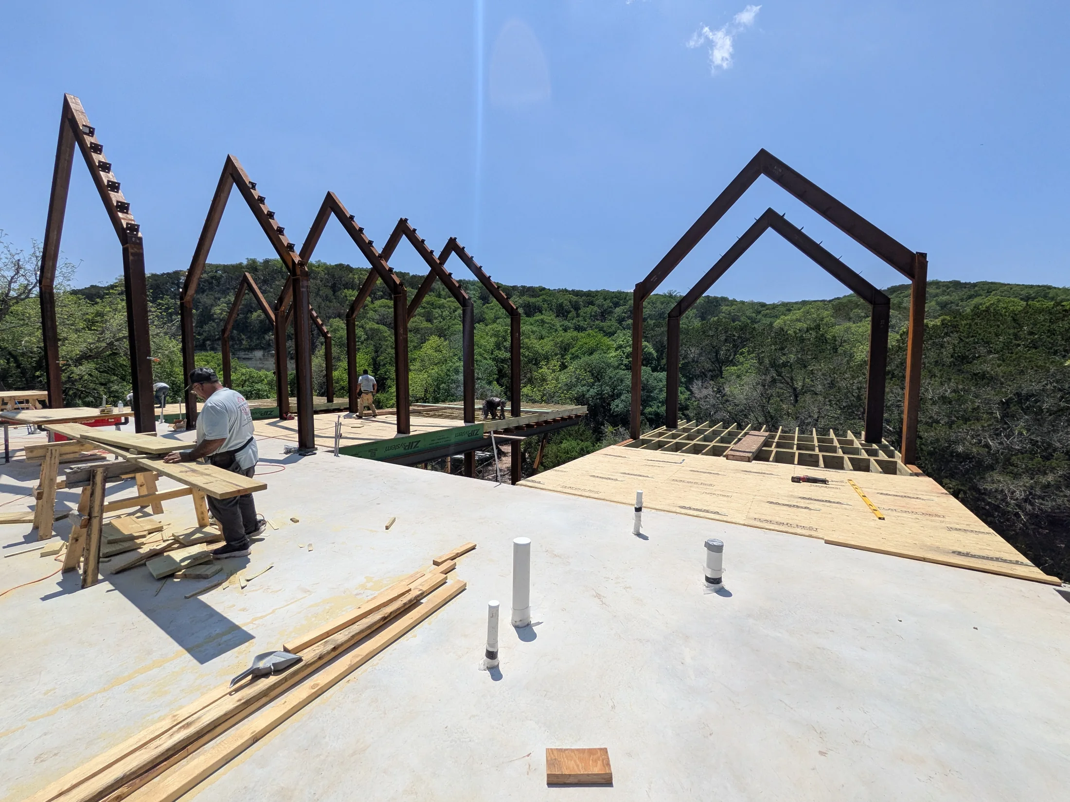 Arroyo Verde deck framing and steel gables over the creek corridor