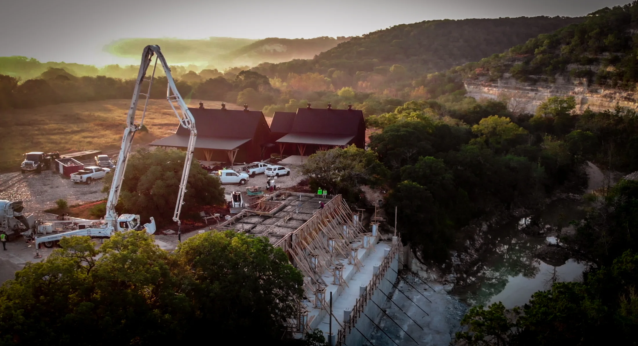 Arroyo Verde drone view over concrete work, creek water, and limestone bluff